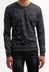 Black sweatshirt with a round neckline, featuring white constellation and mathematical pattern. Ribbed cuffs and hem add texture.