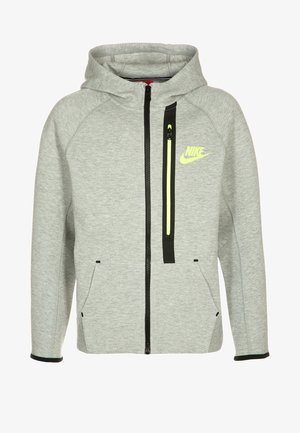 Šedá mikina s kapucí z měkké látky. Má černý zip, dvě přední kapsy a neonově žluté logo na hrudi.