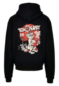 Čierna mikina s kapucňou s bielym a červeným vintage grafickým motívom "Tom a Jerry" na chrbte, zobrazuje kreslené postavičky a živé detaily.