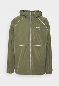 Olive green Nike jacket with a hood, zippered front, and elastic cuffs, featuring white accents and the "AIR" logo on the chest. Lightweight material.