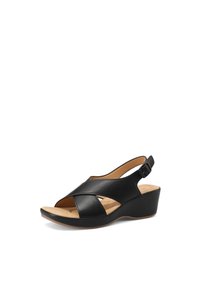 Sandali con tacco a cuneo neri in pelle, con fasce incrociate e cinturino alla caviglia regolabile. La soletta imbottita color marrone chiaro aggiunge comfort.