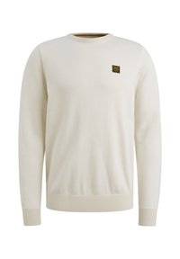 Maglione beige chiaro realizzato in materiale morbido, con colletto rotondo e polsini a coste. Un piccolo etichetta nera è cucita sul petto.