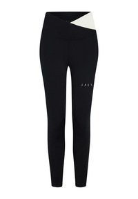 Svarta sportleggings med hög midja som har en vit korsdesign upptill och subtila utskärningar på benet.