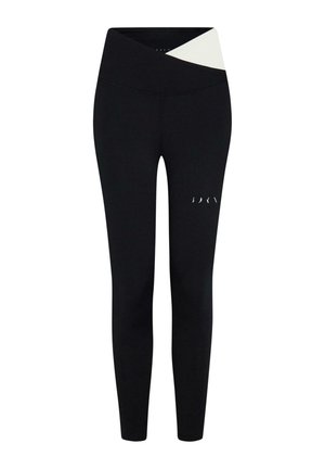 Svarta sportleggings med hög midja som har en vit korsdesign upptill och subtila utskärningar på benet.