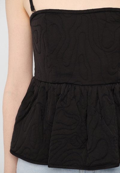Black peplum top with thin straps, featuring textured stitching in wave patterns and gathered fabric at the waist, creating a billowing effect.