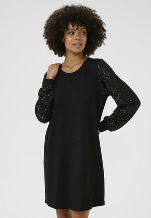 Schwarzes Kleid mit langen, strukturierten Ärmeln aus schwarzen Pailletten. Glattes Design des Körpers, runder Ausschnitt und leicht lockere Passform für Komfort.