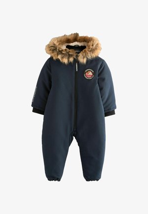Marineblauer Skianzug mit Kapuze aus Kunstfell, Reißverschluss vorne, gerippten Bündchen und Logopatch auf der Brust. Weicher, glatter Stoff mit elastischen Bündchen.