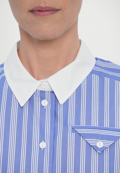Blue and white striped shirt with a white collar, featuring a double-button placket and a pocket with matching stripes on one side.