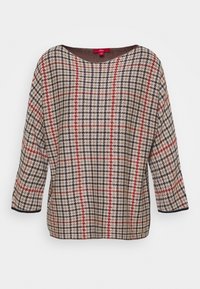 Pullovertrøje i et hundetand mønster med beige, rød og sort farver. Bred halsudskæring og trekvartærmer med mørke kanter.