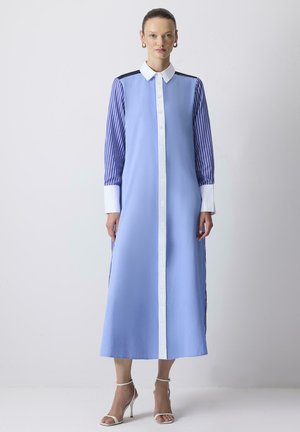 Long-sleeve dress in light blue with striped sleeves, white collar, and front button closure. Smooth fabric with tailored fit.