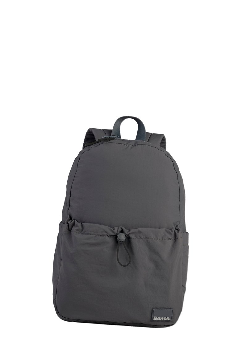 Gray nylon backpack with a rounded top, adjustable straps, front cinch pocket, and a rectangular base. Features a brand logo on the front.