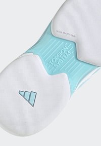 White shoe sole with a textured pattern, featuring a translucent blue accent and "TORSION SYSTEM" embossed. Non-marking material.