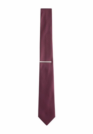 Dark red necktie with a small blue dot pattern and a silver tie clip on a white background.