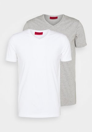 Two v-neck t-shirts: one white and one light gray. Both are made of cotton with short sleeves and a smooth fabric texture.
