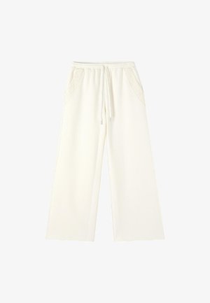 Kremfarvede bukser med brede ben, elastik i taljen, bindesnor og blondedetalje på forlommerne.