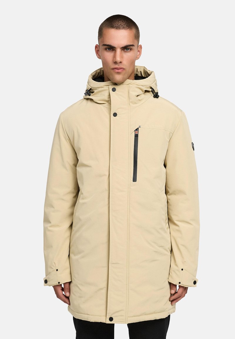 Beige pufferjacka med en dragkedja i frampocket, justerbar dragsko under huven och knäppte ärmslut. Slät tyg med en varm, isolerad design.