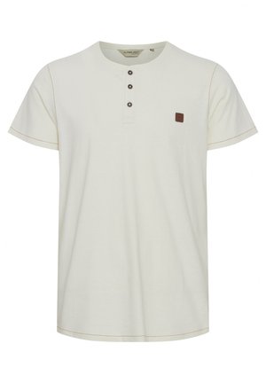 Light beige henley t-shirt featuring short sleeves, three buttons at the collar, and a small brown logo patch. Contrast stitching accents the design.