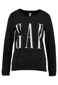 Felpa nera con scollatura a girocollo e maniche lunghe, con grande logo "GAP" in glitter argentato davanti. Tessuto morbido.