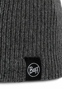 Gray knitted beanie with vertical ribbing texture, featuring a black fabric label with white text "Buff" attached to the side.