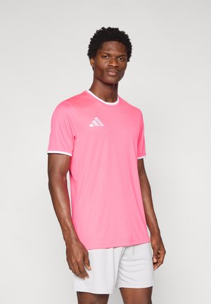 Pink athletic shirt with white accents and Adidas logo on the left chest. Short sleeves and round neckline. Lightweight, smooth fabric.