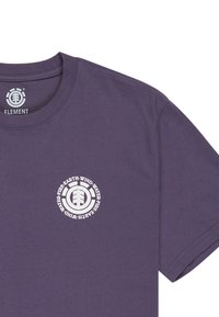 Lila Baumwoll-T-Shirt mit einem runden weißen Logo und dem Text "Erde-Wind-Feuer-Wasser", klassischem Rundhalsausschnitt und kurzen Ärmeln.