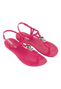 Infradito rosa in gomma con fasce incrociate, dotate di dettagli in perline metalliche e soletta testurizzata. Cinghia posteriore regolabile per una vestibilità perfetta.