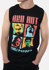 Black sleeveless shirt featuring four colorful square images of band members, with "RED HOT CHILI PEPPERS" text in bold blue.