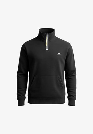 Schwarzer Pullover mit hohem Kragen, halbem Reißverschluss und gelbem Zipper. Hat eine Fronttasche und ein kleines Logo auf der Brust.