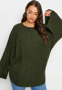 Mörkgrön oversized sweatshirt med rund halsringning, långa trumpetärmar och mjuk textur. Har en enkel, sömlös design.