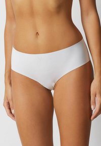 Białe hipsterskie majtki wykonane z gładkiego, elastycznego materiału. Posiadają bezszwowy krój oraz szeroką elastyczną talię. Minimalistyczny wygląd.