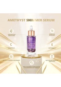 Sérum Améthyste Shimmer dans un flacon en verre transparent avec un bouchon compte-gouttes. Le liquide est violet avec des effets scintillants. Accents dorés autour de l'étiquette.
