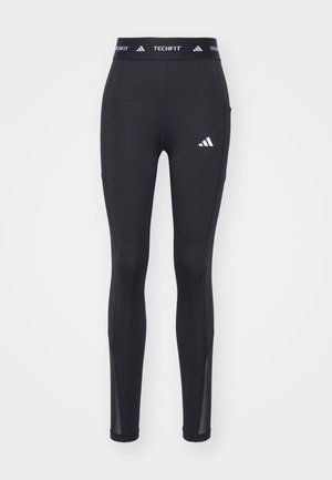 Leggings sportivi neri con un design aderente, realizzati in materiale elasticizzato, caratterizzati da un logo all'altezza dell'anca e inserti in mesh alla caviglia.