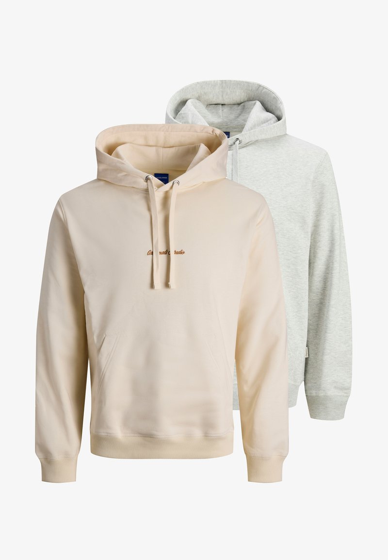 Two hoodies displayed; one in light beige with a front pocket and embroidered text, the other in light gray with a relaxed fit.