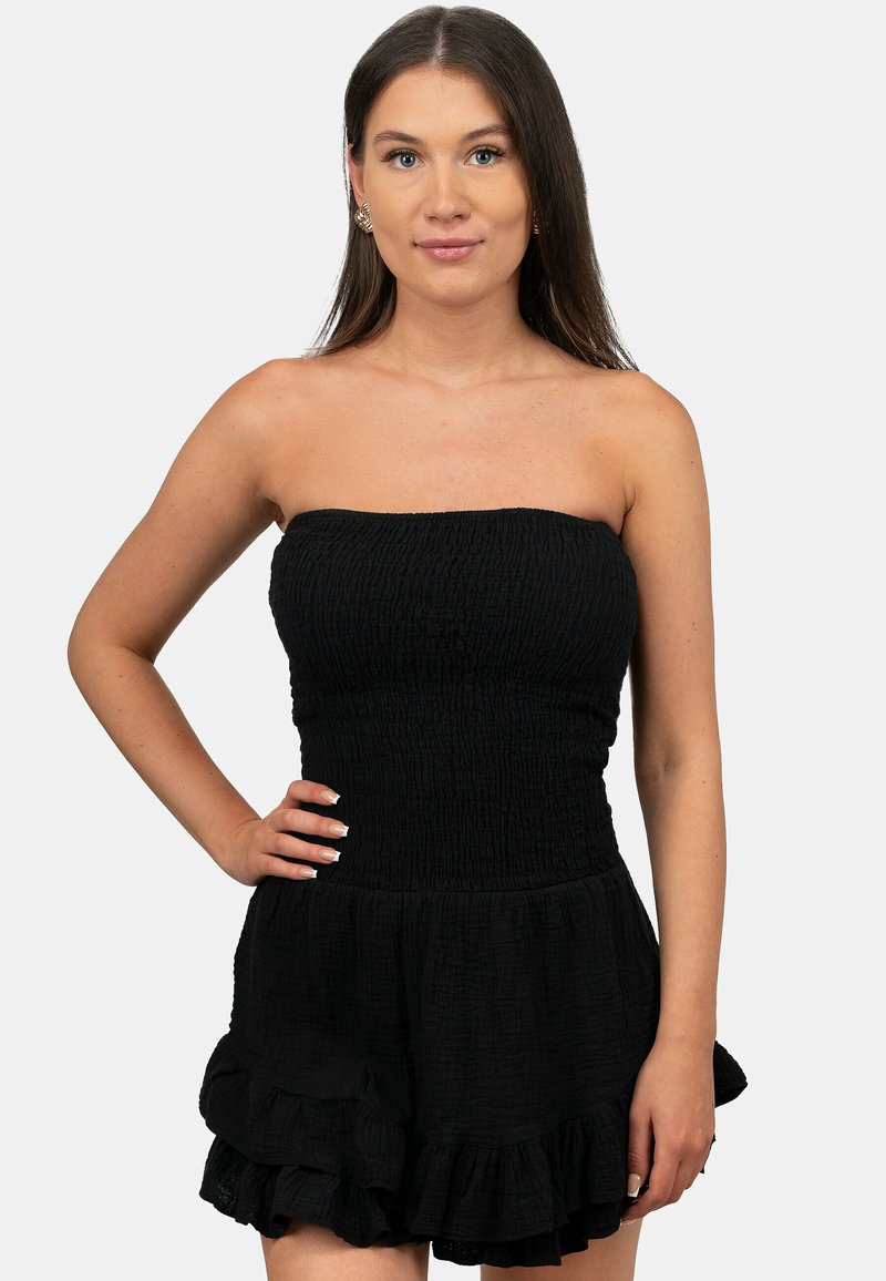 Zwarte jumpsuit met een gerimpelde buste, strapless ontwerp en een gerimpelde zoom. Gemaakt van structuurstof, met een uitlopende rok.