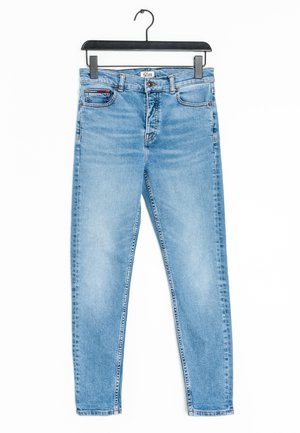 Light blue denim jeans with a slim fit, five pockets, and button closure hanging from a black hanger against a white background.