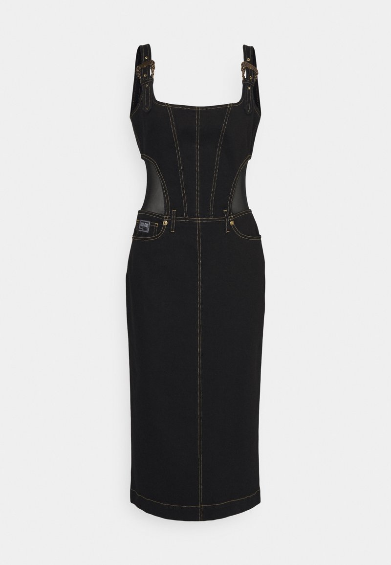 Robe en denim noir avec un corsage ajusté. Elle présente des coutures dorées, des bretelles réglables avec des accents en chaîne, et des panneaux latéraux en cuir. Style mi-long.