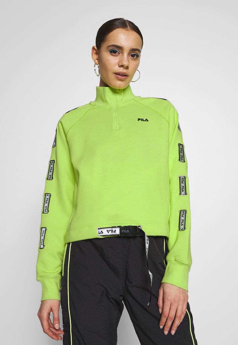 Pullover in pile con cerniera, di colore verde neon, con logo sul petto. Dettagli neri sulle spalle e nastro con marchio lungo le maniche. Vestibilità casual e rilassata.