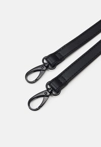 Black leather strap featuring two metal clips at each end. The surface is smooth with visible stitching and a minimalist design.