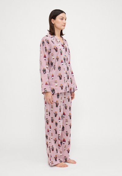 Red and white striped pajama set with floral and character patterns. The top features a button-up design; the pants are loose-fitting.