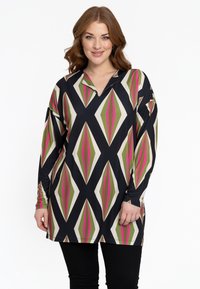 Gemusterte Tunika in Schwarz, mit einem geometrischen Design und Diamantformen in Grün, Pink und Creme. Lange Ärmel und ein kragenförmiger Ausschnitt.