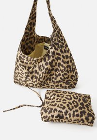 Leopard print fabric bag with brown and beige tones, featuring a spacious interior and a matching pouch. Texture is smooth and lightweight.