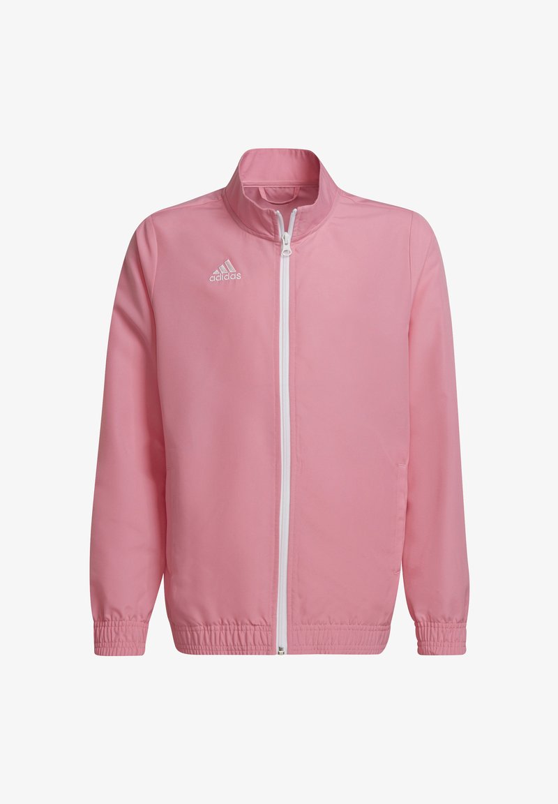 Giacca leggera rosa con zip frontale, collo alto, polsini ed elastico in vita. Presenta il logo bianco Adidas nella parte alta a sinistra.