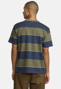 Men's short-sleeve t-shirt with horizontal stripes in navy, olive green, and tan. Cotton material with a relaxed fit and crew neckline.