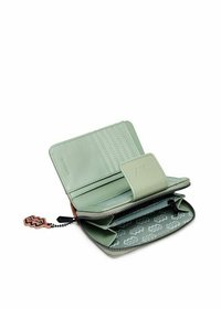 Green leather wallet with multiple card slots, zip enclosure, and patterned interior lining. Features a decorative charm attached to zipper.