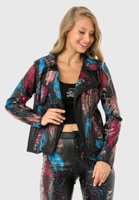 Black leather biker jacket featuring multicolored paint splatter patterns in blue, pink, and red; zip closure and lapel collar.