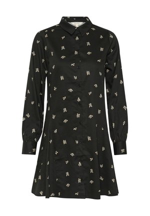 Čierne šaty s dlhými rukávmi a gombíkmi, vyrobené z textúrovanej tkaniny, s malými kvetinovými vzormi v bielej a svetložltej farbe po celom povrchu.