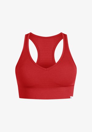 Bralette sportivo rosso a coste con scollatura a V e design a spalle scoperte. Presenta pannelli testurizzati e una fascia solida nella parte inferiore.