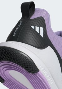 Purple and black athletic shoe with textured material, prominent heel, and rubber outsole. Features white logo and accents.