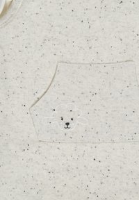 Light gray flecked fabric with a small, embroidered sheep design on a pocket. Crew neck and soft, textured material.