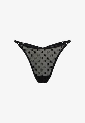 Melnas tanga apakšveļas bikses no caurspīdīga sieta ar atkārtotu mazu simbolu rakstu. Ar mežģīņu apdari un cietu jostu atbalstam.